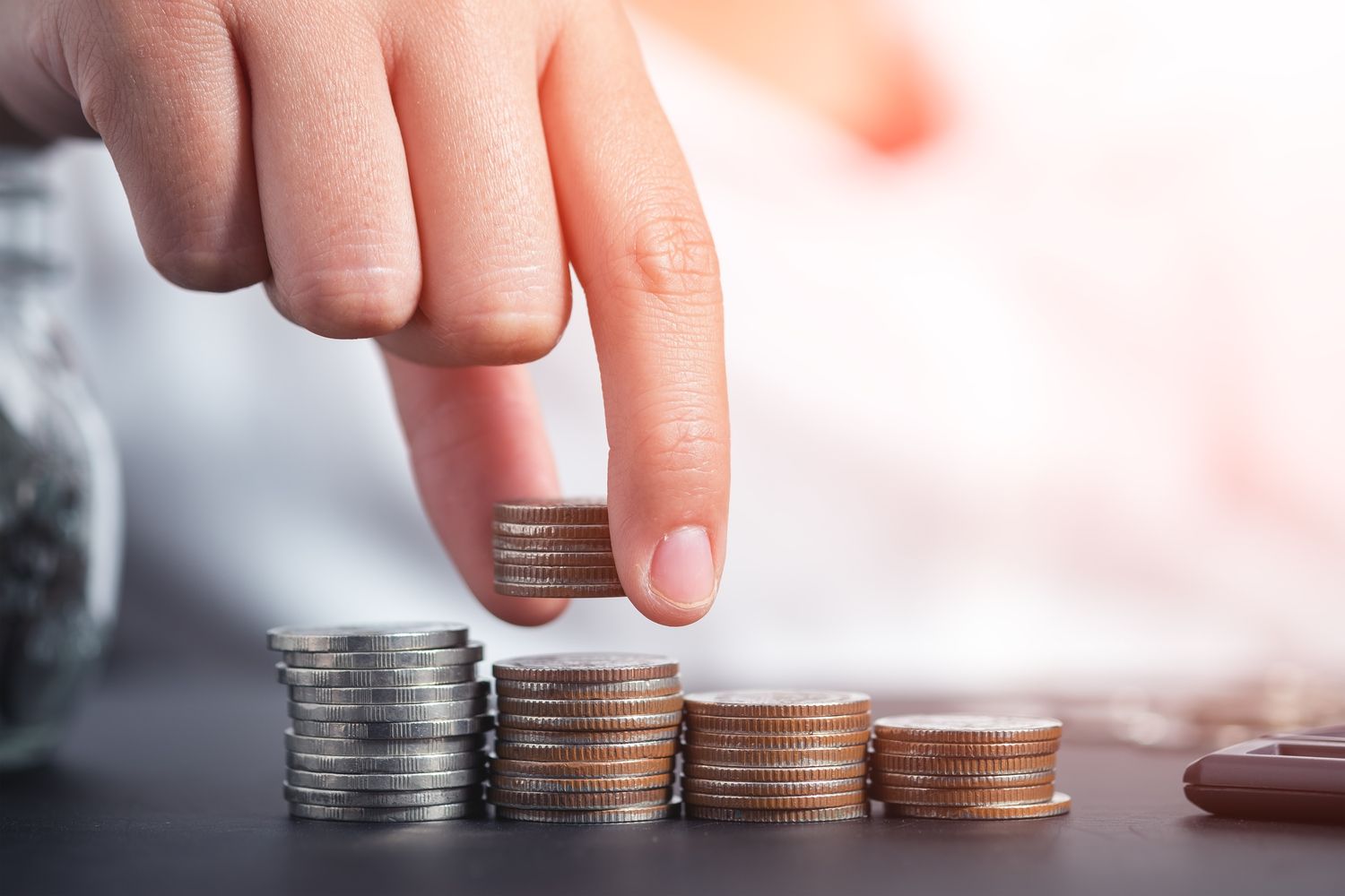 stacking coins (structuresxx/Shutterstock)